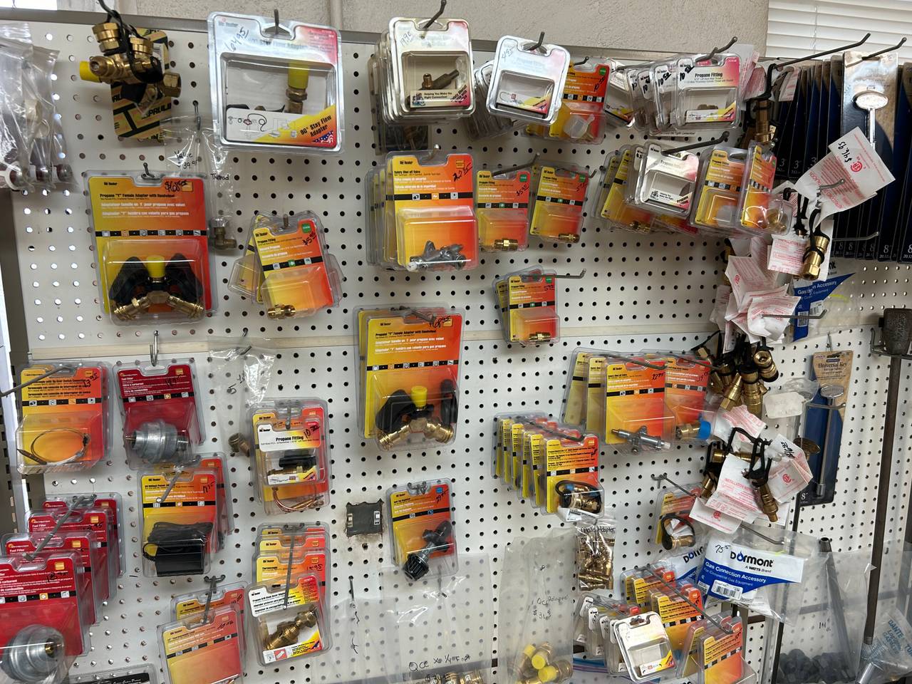 Propane valves, adapters, and fittings display at Action Propane storefront